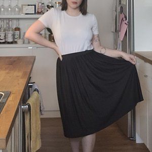 Pleated black stretch midi skirt